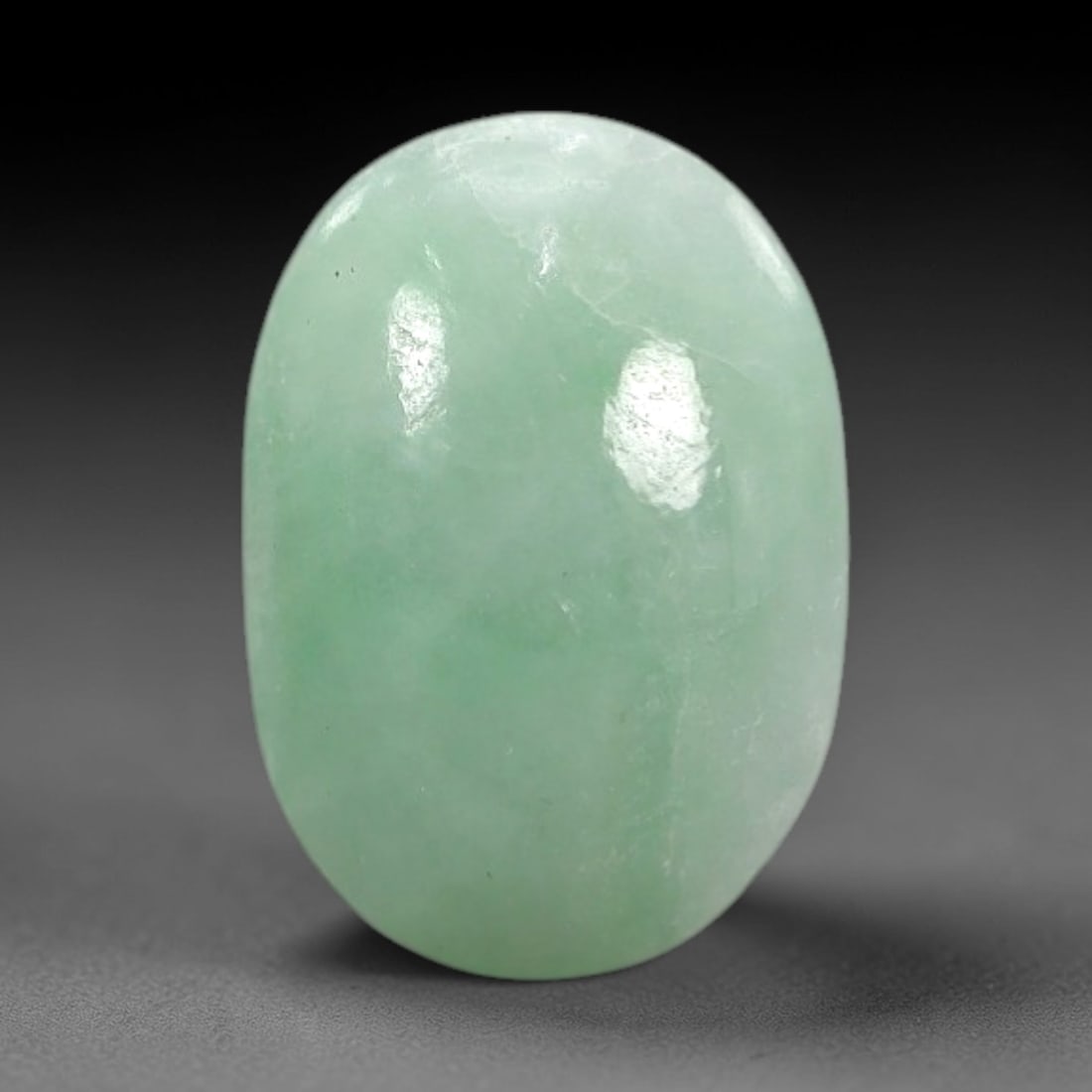 3.00 Carats Apple Green Burmese Jadeite Jade Cabochon - Natural Loose Gemstone, 67XN: This singular Burmese jadeite jade cabochon presents a luminous apple green hue, soft and luminous with a translucent quality that allows light to filter gently through its smooth, domed surface. The