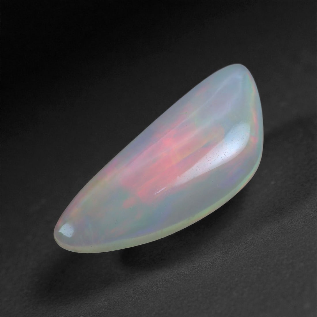 4.29 Carats Play-of-Color Welo Opal - Natural Ethiopian Gem 22x9mm, 39XA: This captivating Welo opal gleams with a luminous cascade of multi neon color that ripple across the stone's surface with every movement. The play-of-color is vivid and well-distributed, presenting a 