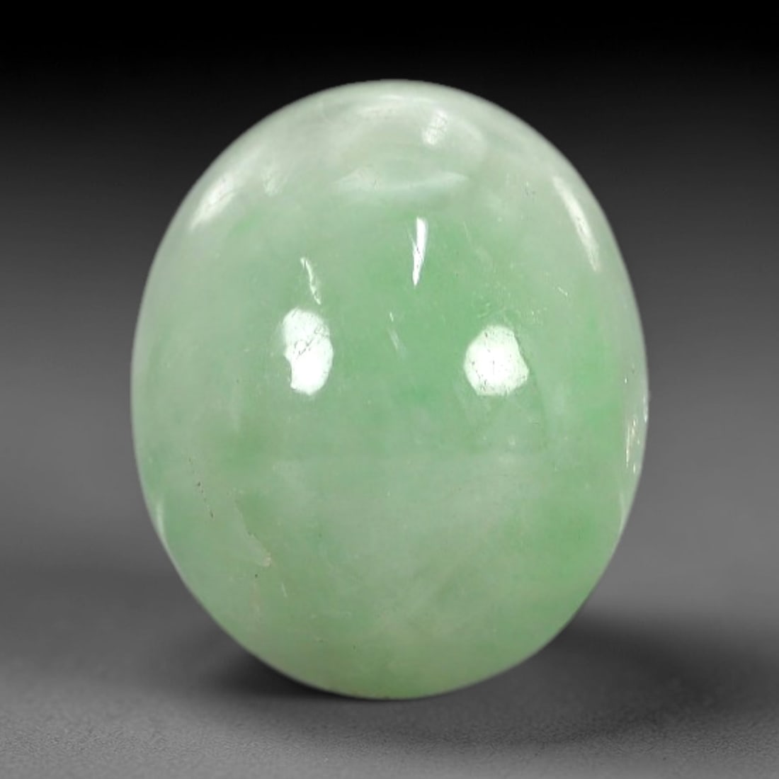 3.88 Carats Apple Green Burmese Jadeite Jade Cabochon - Natural Loose Gemstone, 74XN: This singular Burmese jadeite jade cabochon presents a luminous apple green hue, soft and luminous with a translucent quality that allows light to filter gently through its smooth, domed surface. The