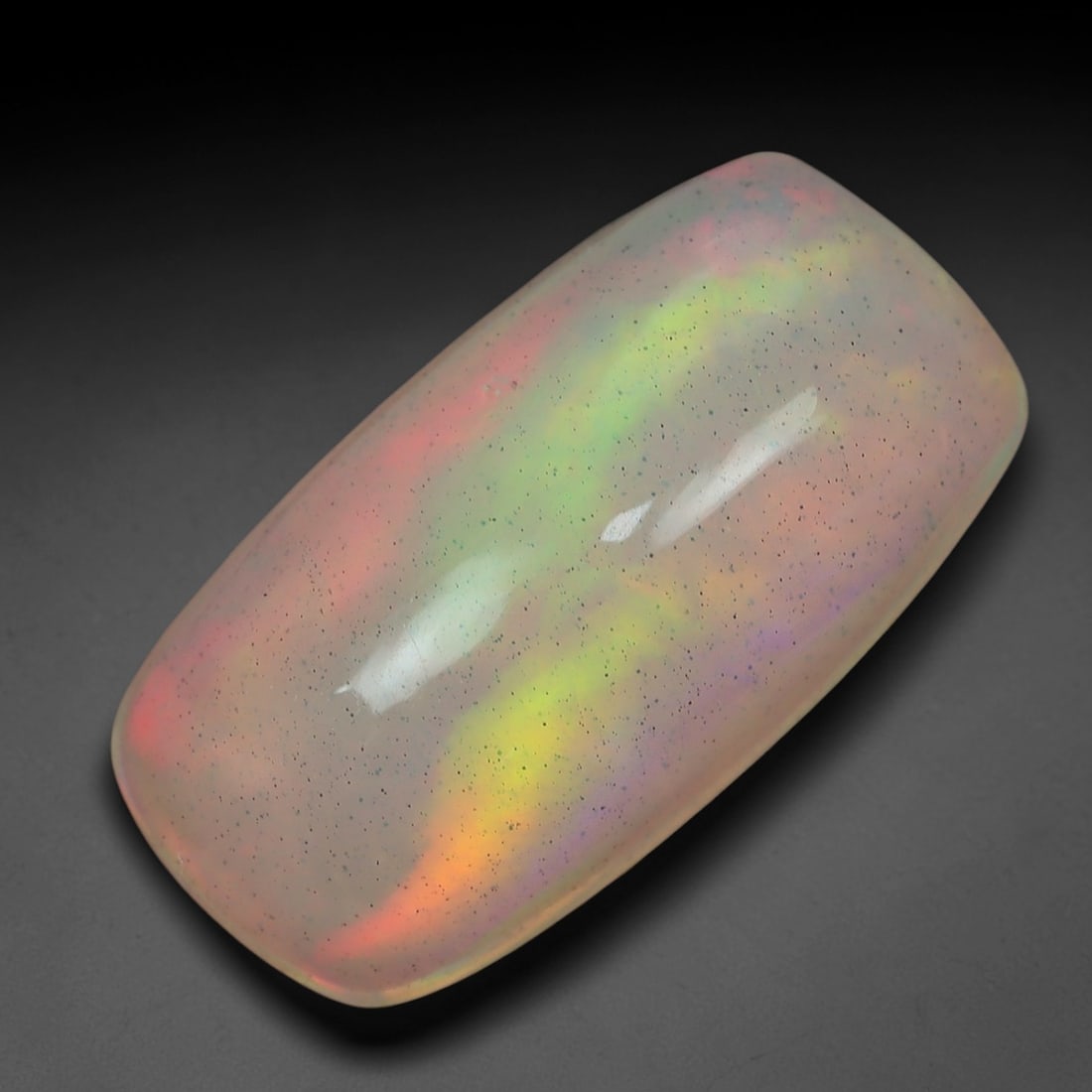 3.41 Carats Pastel Rainbow Flash Ethiopian Welo Opal - Natural Loose Gemstone, 86XN: This extraordinary Ethiopian Welo opal unfolds a dreamy pastel rainbow play-of-color, with soft bands of rose pink, lemon yellow, lime green, and lavender flowing seamlessly across a pale, milky base.