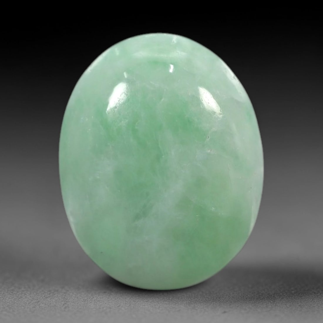 4.35 Carats Apple Green Burmese Jadeite Jade Cabochon - Natural Loose Gemstone, 81XN: This singular Burmese jadeite jade cabochon presents a luminous apple green hue, soft and luminous with a translucent quality that allows light to filter gently through its smooth, domed surface. The