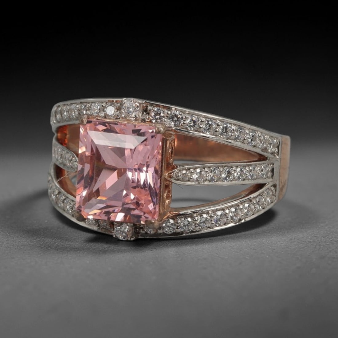 A Modern Silver and Chatham Diffusion Sapphire Ring, 20th Century, 88FT: Crafted from stamped 925 silver with a two-tone finish, the ring features a central square-cut Chatham diffusion sapphire of soft pink hue, secured by four prongs within a rose gold-toned bezel. The b