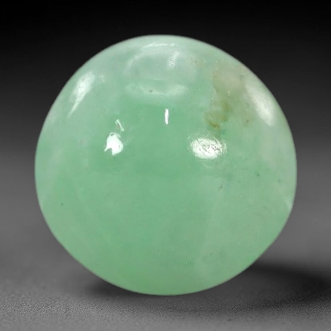 2.31 Carats Apple Green Burmese Jadeite Jade Cabochon - Natural Loose Gemstone, 30XN: This singular Burmese jadeite jade cabochon presents a luminous apple green hue, soft and luminous with a translucent quality that allows light to filter gently through its smooth, domed surface. The