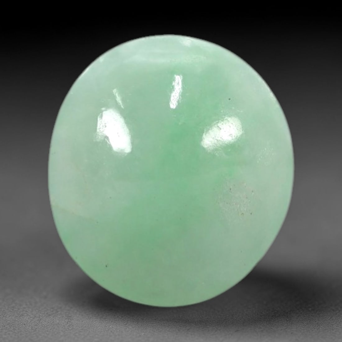 3.00 Carats Apple Green Burmese Jadeite Jade Cabochon - Natural Loose Gemstone, 43XN: This singular Burmese jadeite jade cabochon presents a luminous apple green hue, soft and luminous with a translucent quality that allows light to filter gently through its smooth, domed surface. The