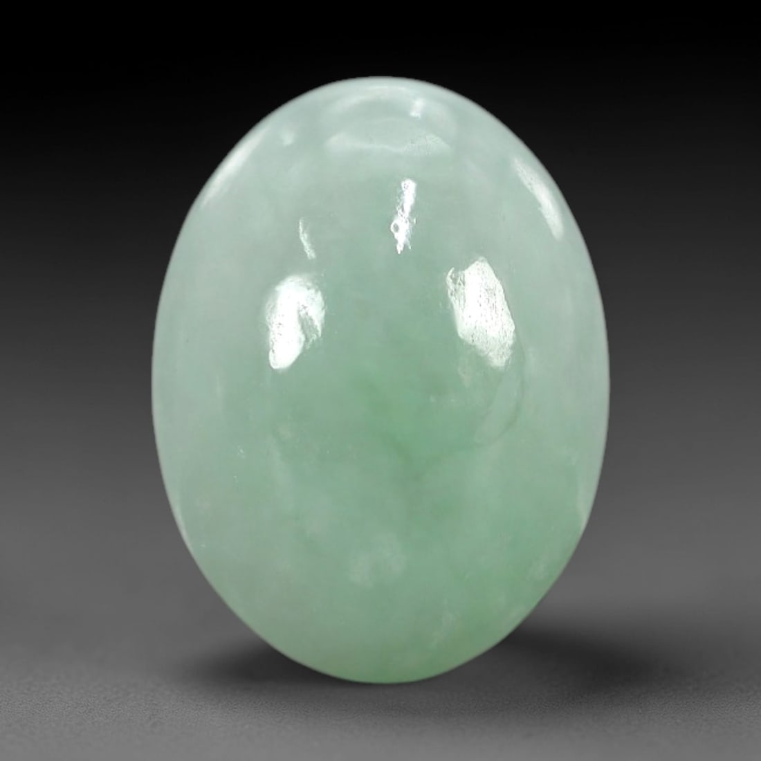 5.37 Carats Apple Green Burmese Jadeite Jade Cabochon - Natural Loose Gemstone, 79XN: This singular Burmese jadeite jade cabochon presents a luminous apple green hue, soft and luminous with a translucent quality that allows light to filter gently through its smooth, domed surface. The