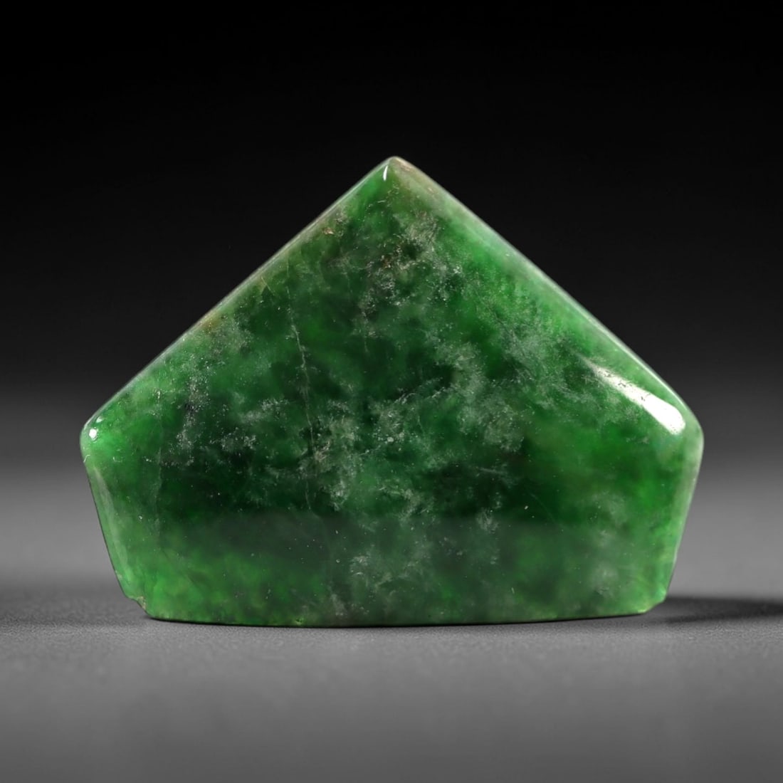 5.91 Carats Rich Green Jadeite Jade Cabochon - Natural Burmese Stone, 49AB: This rich green jadeite jade cabochon features a distinctive, angular form with a vibrant, saturated green hue that transitions to softer, milky undertones across its polished surface. The stone's eve