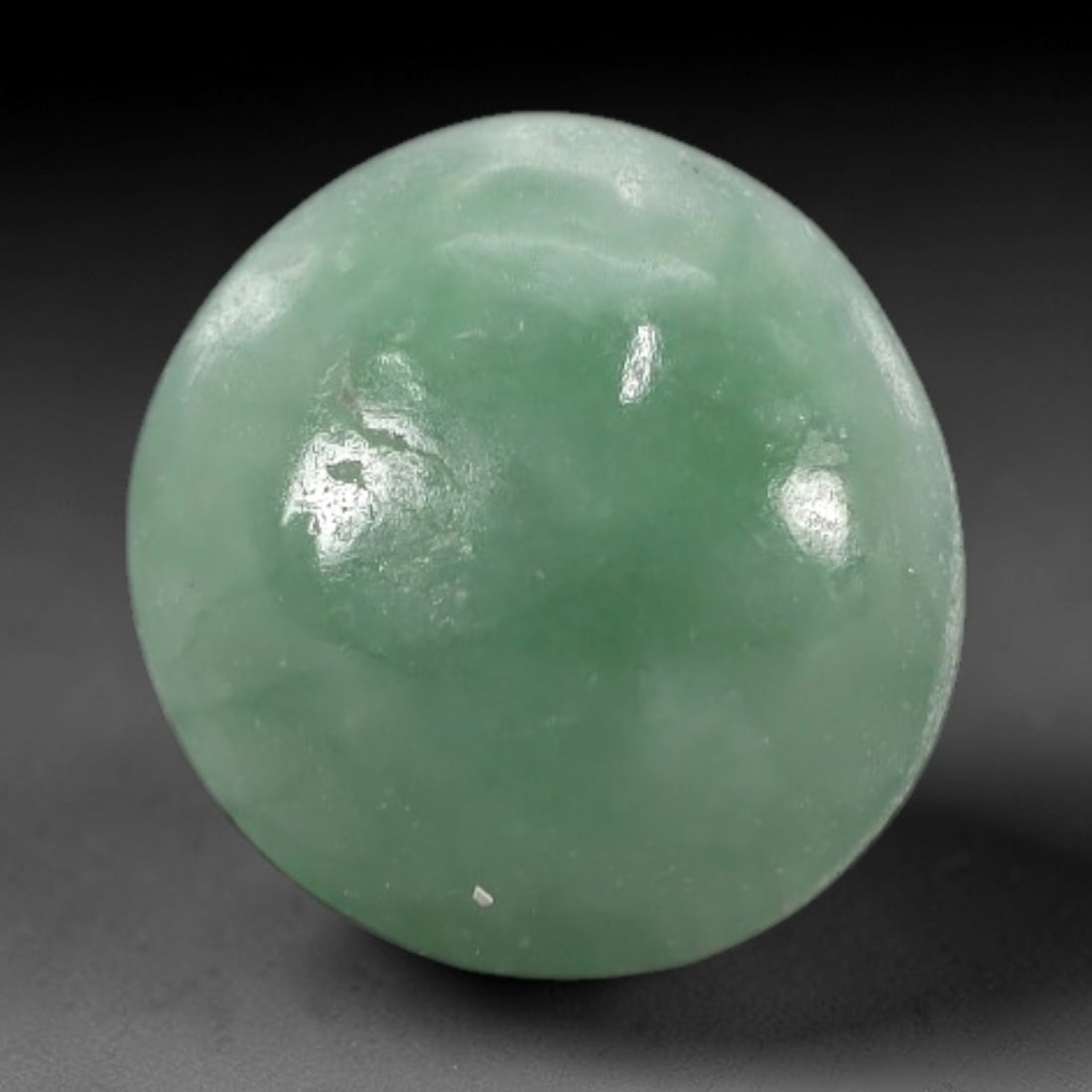 3.09 Carats Apple Green Burmese Jadeite Jade Cabochon - Natural Loose Gemstone, 36XN: This singular Burmese jadeite jade cabochon presents a luminous apple green hue, soft and luminous with a translucent quality that allows light to filter gently through its smooth, domed surface. The