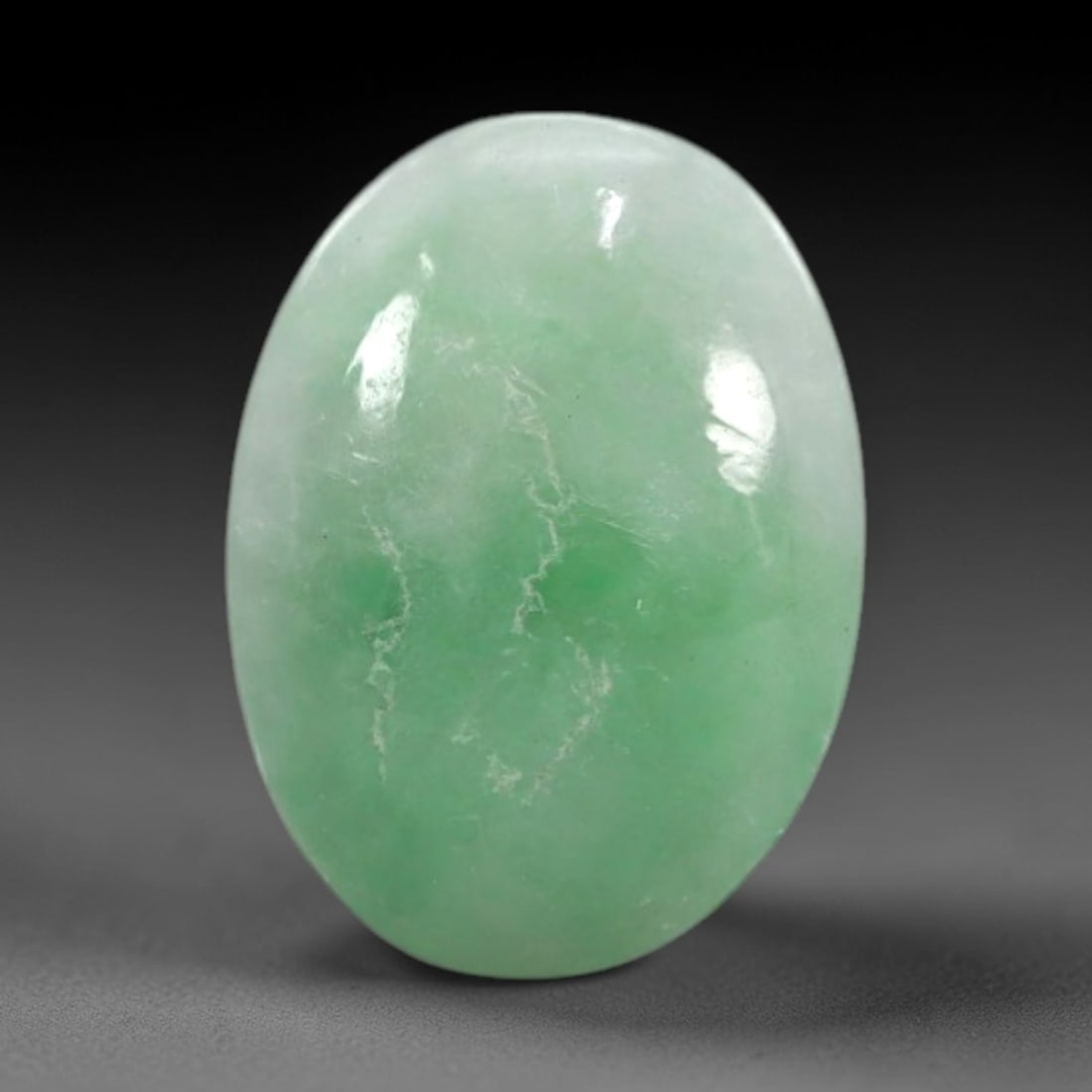 2.22 Carats Apple Green Burmese Jadeite Jade Cabochon - Natural Loose Gemstone, 46XN: This singular Burmese jadeite jade cabochon presents a luminous apple green hue, soft and luminous with a translucent quality that allows light to filter gently through its smooth, domed surface. The