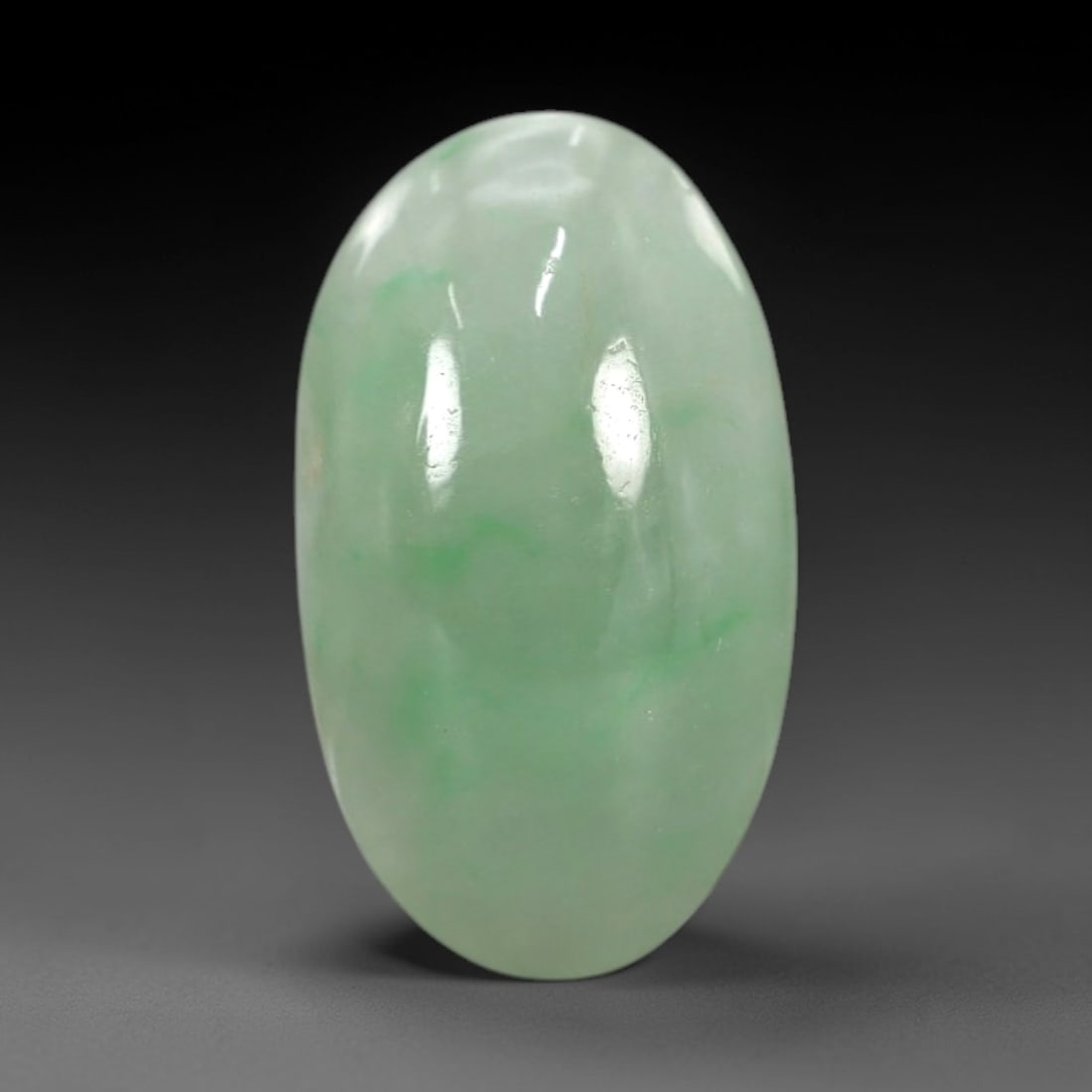 3.95 Carats Apple Green Burmese Jadeite Jade Cabochon - Natural Loose Gemstone, 57XN: This singular Burmese jadeite jade cabochon presents a luminous apple green hue, soft and luminous with a translucent quality that allows light to filter gently through its smooth, domed surface. The