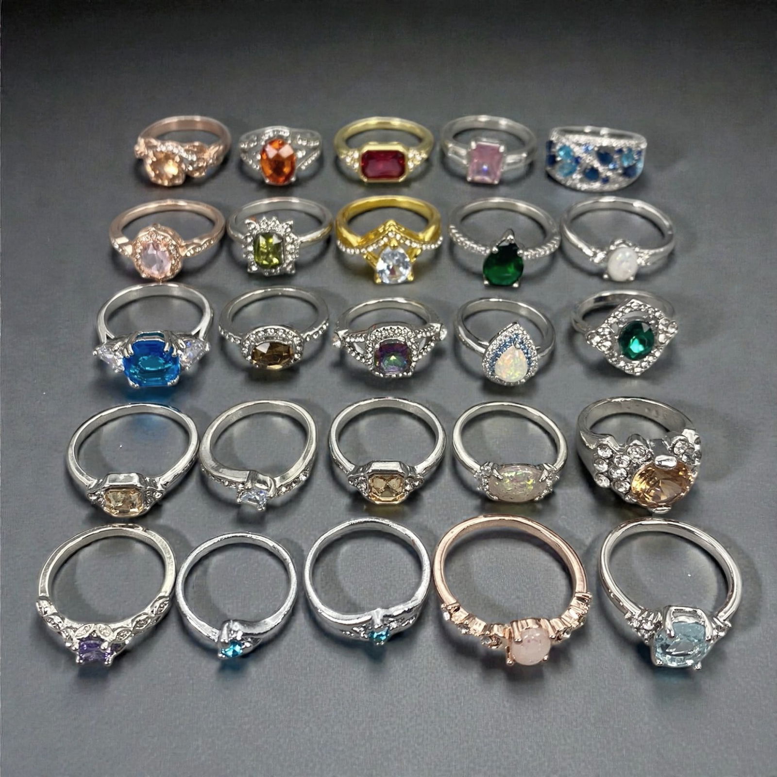 A Group of Modern Metal and Gem-Set Fashion Rings, Late 20th-Early 21st Century, 69XJ: Comprising twenty-five modern fashion rings constructed from mixed base metals and non-precious alloys, the group presents a wide range of contemporary designs set with synthetic, treated, or simulate