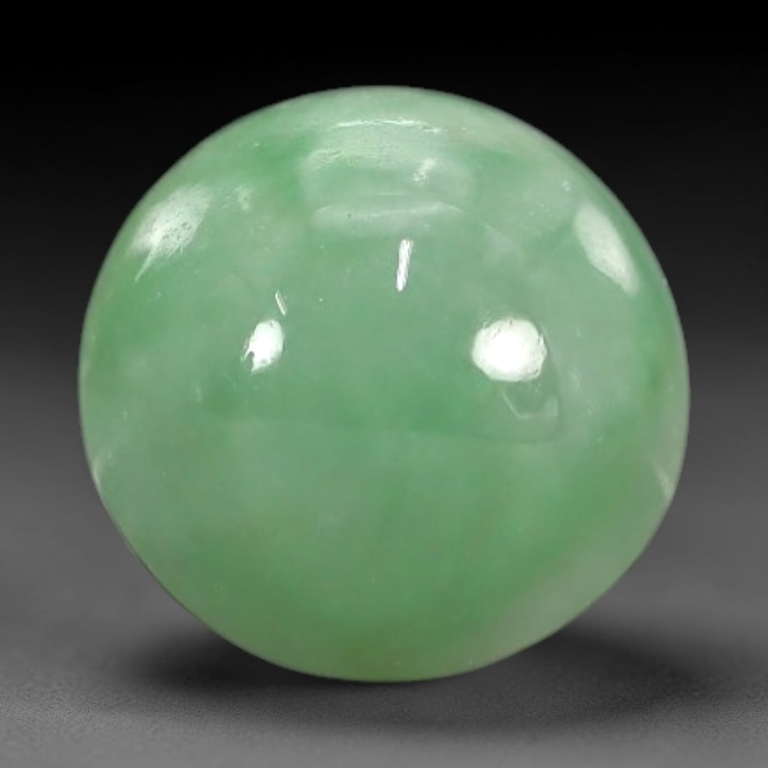 2.66 Carats Apple Green Burmese Jadeite Jade Cabochon - Natural Loose Gemstone, 38XN: This singular Burmese jadeite jade cabochon presents a luminous apple green hue, soft and luminous with a translucent quality that allows light to filter gently through its smooth, domed surface. The