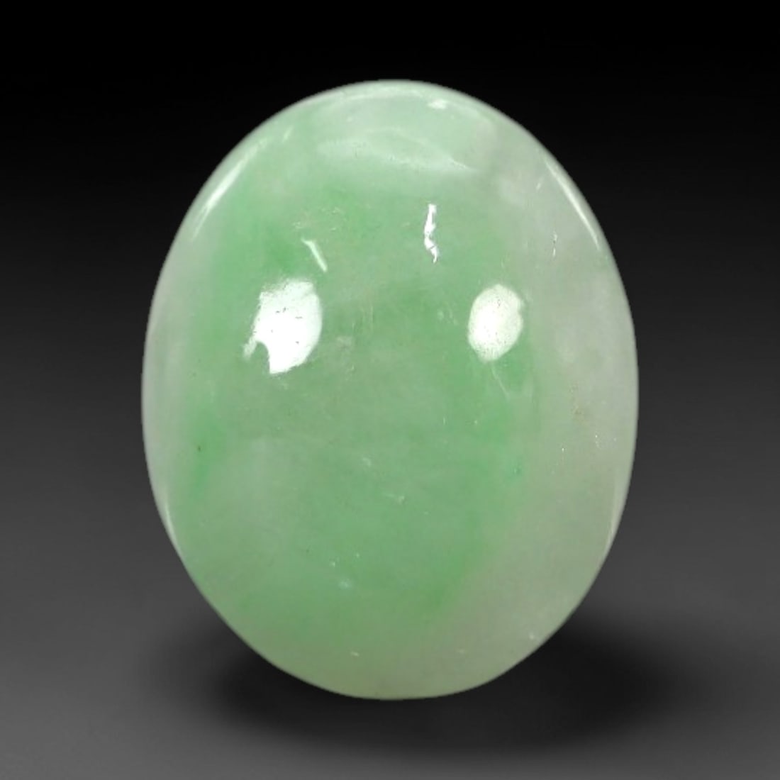 2.70 Carats Apple Green Burmese Jadeite Jade Cabochon - Natural Loose Gemstone, 52XN: This singular Burmese jadeite jade cabochon presents a luminous apple green hue, soft and luminous with a translucent quality that allows light to filter gently through its smooth, domed surface. The