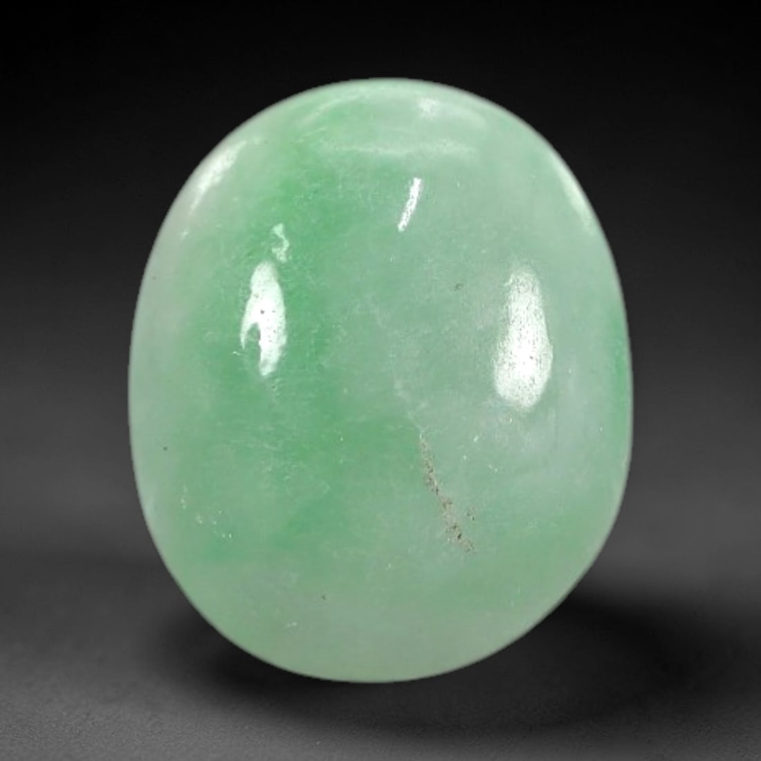 2.22 Carats Apple Green Burmese Jadeite Jade Cabochon - Natural Loose Gemstone, 31XN: This singular Burmese jadeite jade cabochon presents a luminous apple green hue, soft and luminous with a translucent quality that allows light to filter gently through its smooth, domed surface. The