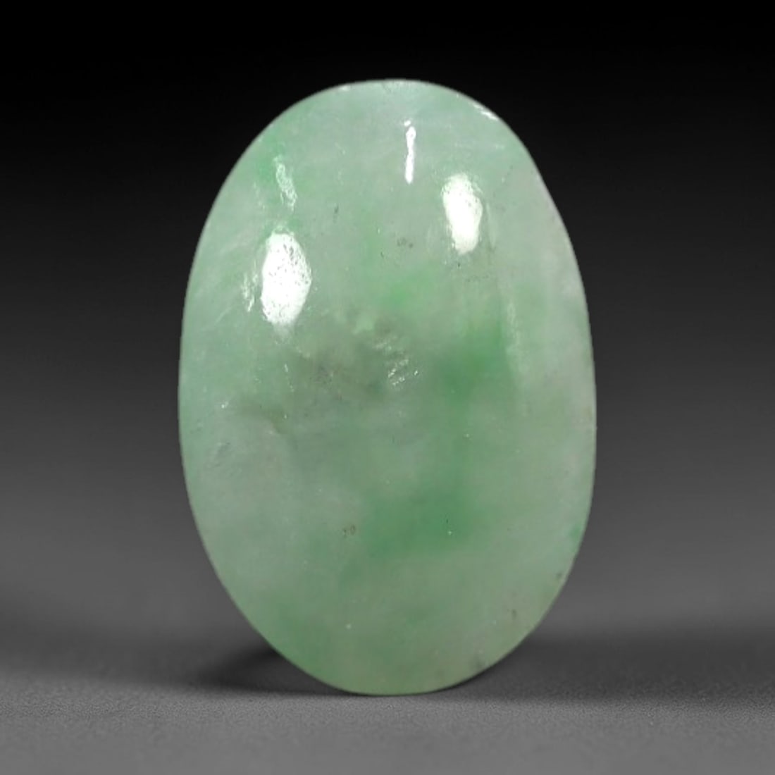 4.75 Carats Apple Green Burmese Jadeite Jade Cabochon - Natural Loose Gemstone, 82XN: This singular Burmese jadeite jade cabochon presents a luminous apple green hue, soft and luminous with a translucent quality that allows light to filter gently through its smooth, domed surface. The
