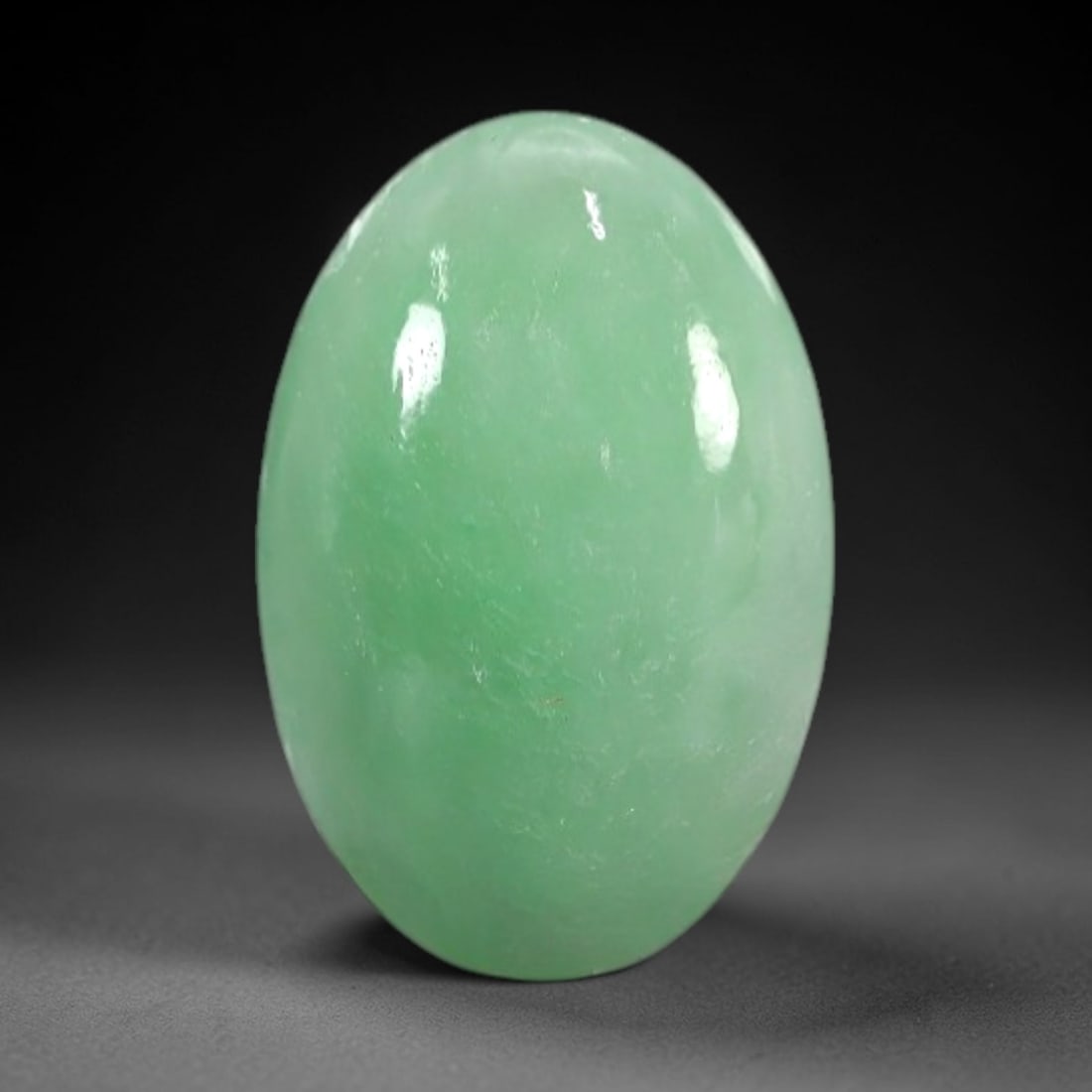 1.78 Carats Apple Green Burmese Jadeite Jade Cabochon - Natural Loose Gemstone, 39XN: This singular Burmese jadeite jade cabochon presents a luminous apple green hue, soft and luminous with a translucent quality that allows light to filter gently through its smooth, domed surface. The