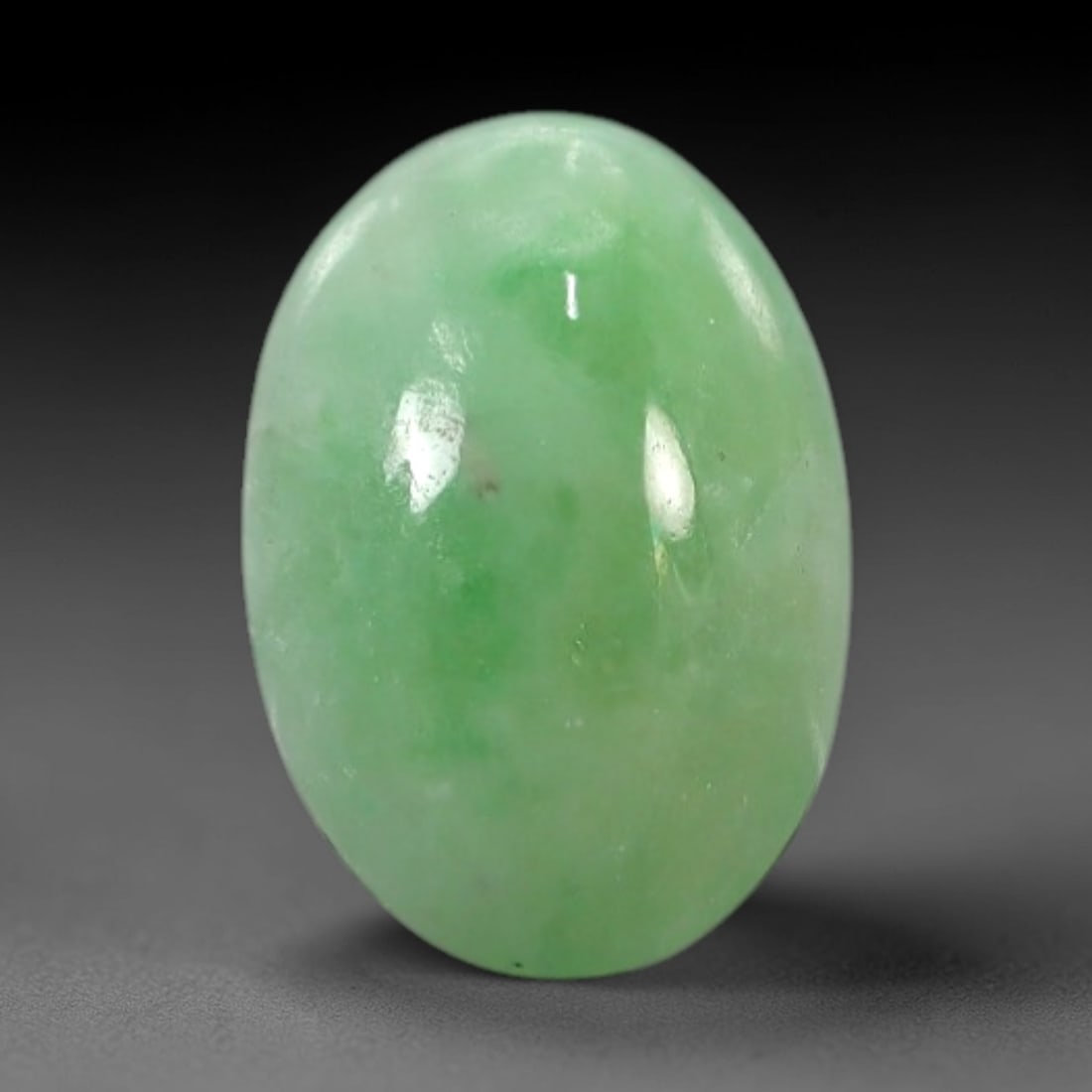 2.60 Carats Apple Green Burmese Jadeite Jade Cabochon - Natural Loose Gemstone, 37XN: This singular Burmese jadeite jade cabochon presents a luminous apple green hue, soft and luminous with a translucent quality that allows light to filter gently through its smooth, domed surface. The