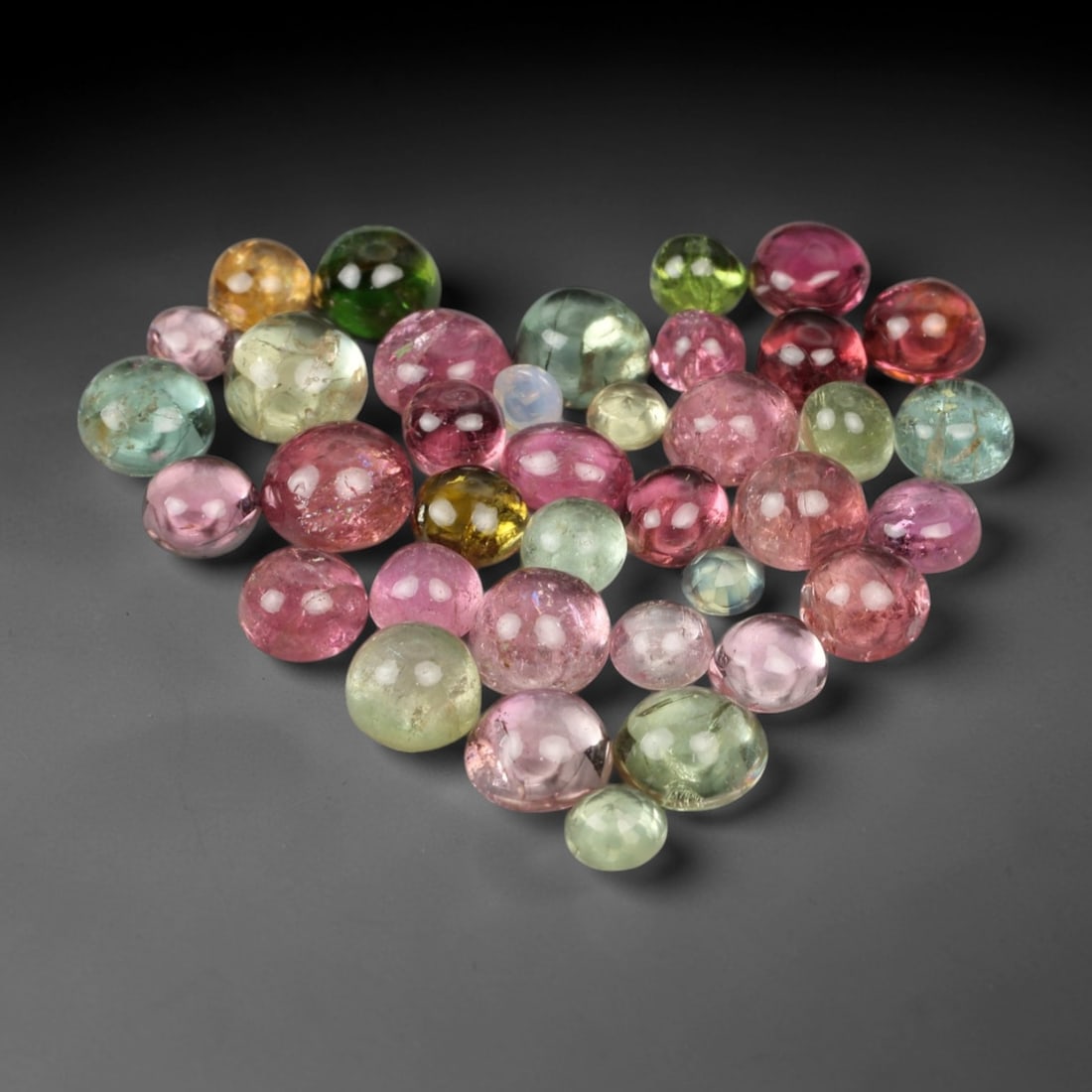 8.86 Carats Fancy Color Tourmaline Cabochon Parcel - Natural Loose Gemstones, 95XN: This vibrant parcel of fancy color tourmaline cabochons, weighing a total of 8.86 carats with individual dimensions ranging from 2.9 to 4.6 mm, bursts with a kaleidoscope of hues. From soft blush pink