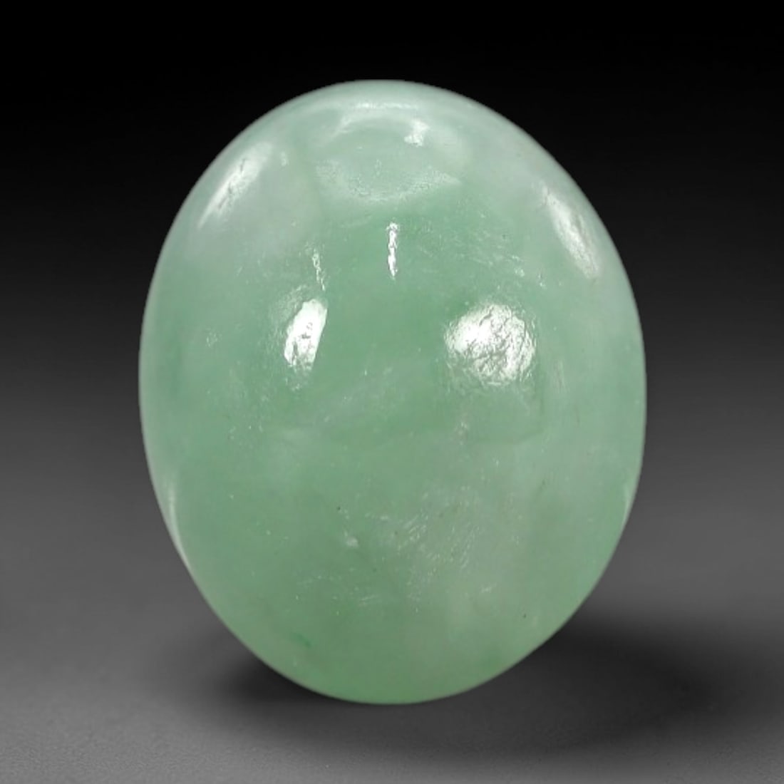 3.95 Carats Apple Green Burmese Jadeite Jade Cabochon - Natural Loose Gemstone, 71XN: This singular Burmese jadeite jade cabochon presents a luminous apple green hue, soft and luminous with a translucent quality that allows light to filter gently through its smooth, domed surface. The
