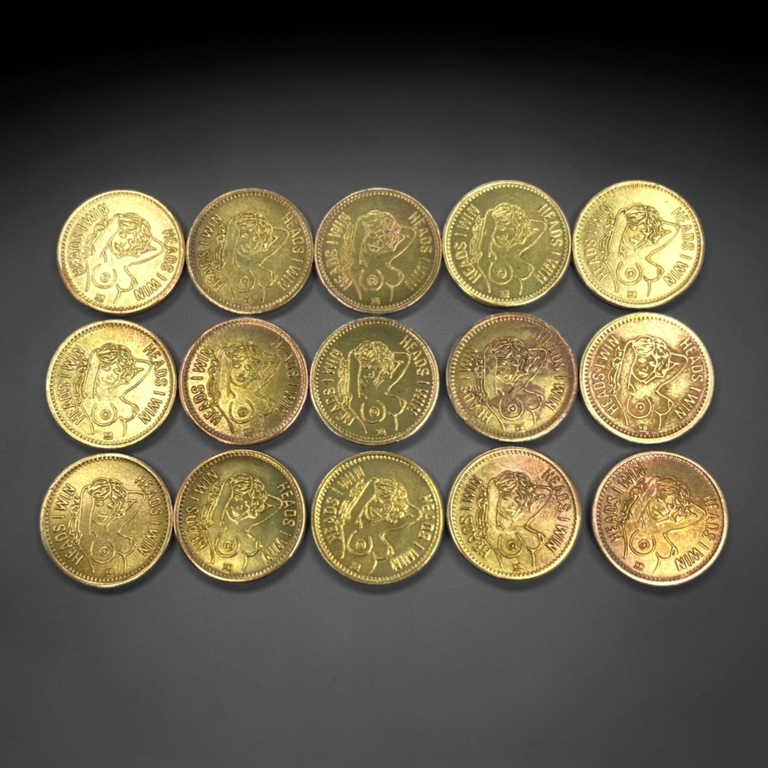 Erotic Gaming - Heads I Win, Tails You Lose 15-Piece Token Set, Mid-Late 20th Century, 23mm, 8ZJ: This complete 15-piece token set encapsulates the playful, risque subculture of mid- to late-20th-century adult novelty gaming. Each brass token features a dual-sided design: the obverse depicts a sty