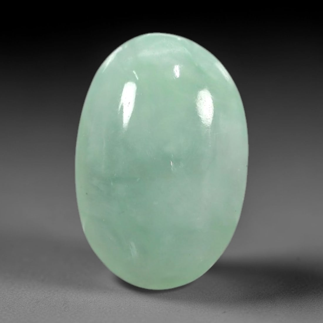 2.54 Carats Apple Green Burmese Jadeite Jade Cabochon - Natural Loose Gemstone, 44XN: This singular Burmese jadeite jade cabochon presents a luminous apple green hue, soft and luminous with a translucent quality that allows light to filter gently through its smooth, domed surface. The