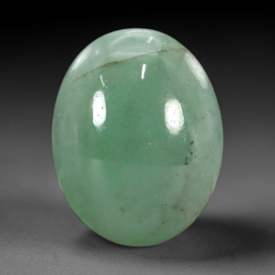 3.77 Carats Apple Green Burmese Jadeite Jade Cabochon - Natural Loose Gemstone, 80XN: This singular Burmese jadeite jade cabochon presents a luminous apple green hue, soft and luminous with a translucent quality that allows light to filter gently through its smooth, domed surface. The