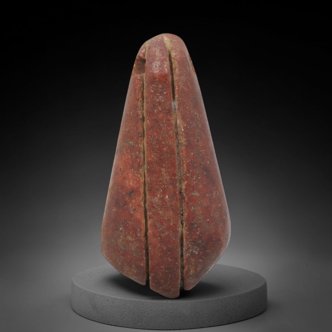 Ancient Red Stone Bud-Form Pendant - Near Eastern Ritual Amulet, 80XP: Carved from a rich, deep red stone with natural earthy patina, this pendant takes the stylized form of a closed floral bud or seed pod, a potent motif in ancient Near Eastern ritual art associated wit