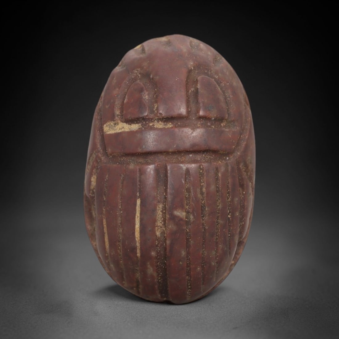 Ancient Red Stone Scarab - Egyptian Amulet Figurine, 3AE: Carved from rich red stone with natural mineral inclusions, this amulet takes the form of an Egyptian scarab, a symbol deeply associated with protection, rebirth, and divine authority in ancient Egypt