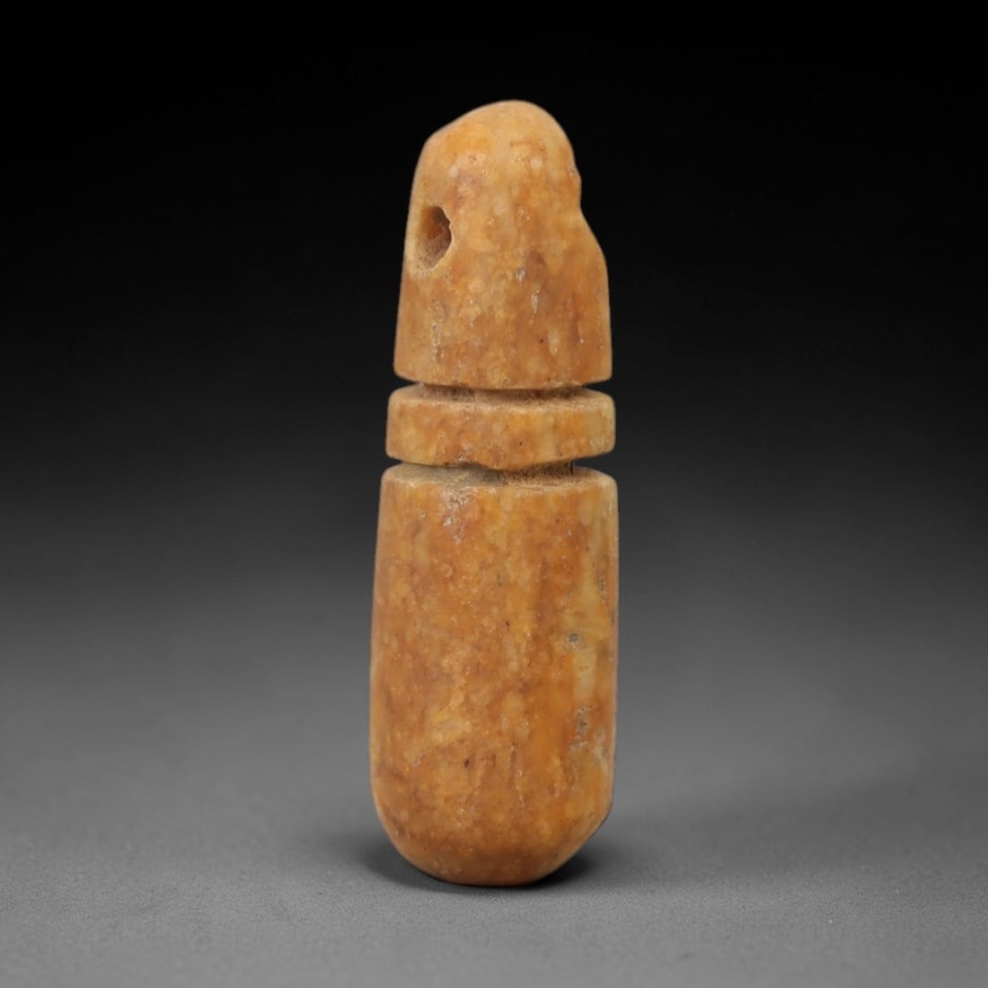 Ancient Stone Wadj Amulet - Egyptian Ritual Figurine, 42AG: This amulet is carved from a single piece of warm amber-hued stone, exhibiting a fine-grained texture with subtle ochre patina and natural mineral inclusions across its surface. The form is a stylized