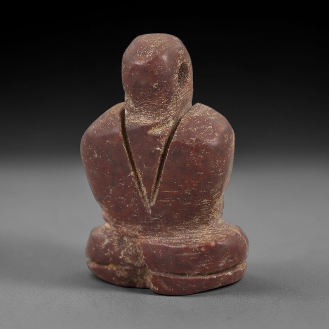 Ancient Egyptian Stone Figurine Amulet - Carved Ritual Idol, 87AE: Carved from reddish-brown stone, this small figurine depicts a humanoid form with incised linear detailing, consistent with ancient Egyptian ritual idols of the Late Period. The piece features a suspe