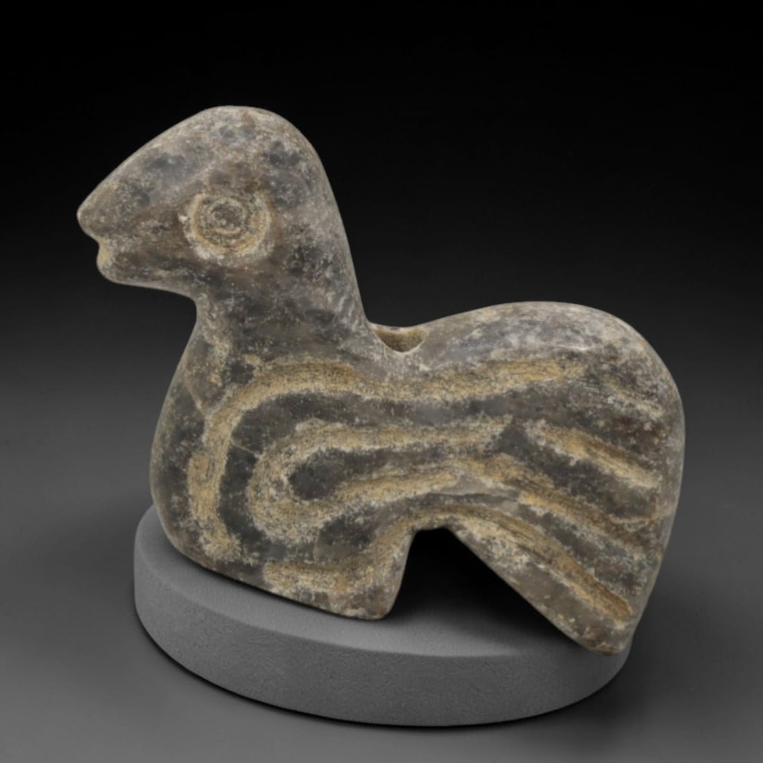 Ancient Stone Bird Amulet - Near Eastern Pendant, 44XQ: Carved from a mottled grey stone with natural earthy patination, this amulet depicts a stylized avian form with a pointed beak, incised circular eye, and a broad curved body adorned with incised linea