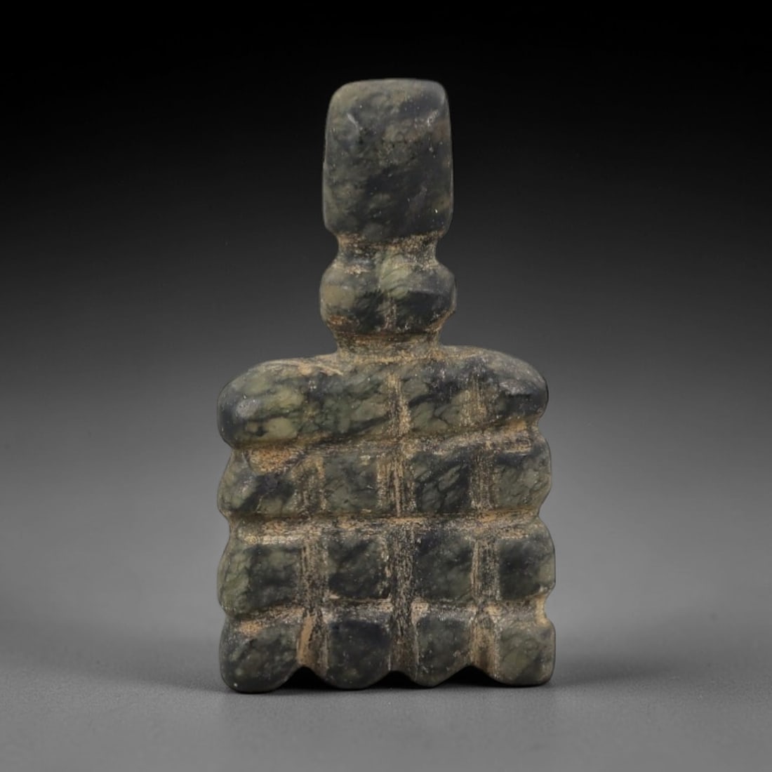 Ancient Egyptian Stone Amulet - Square Grid Carving, 79AG: Carved from stone, this ancient Egyptian amulet features a square form with an incised grid pattern, typical of protective amulets from the Late Period (c. 664-332 BCE). The grid motif was associated