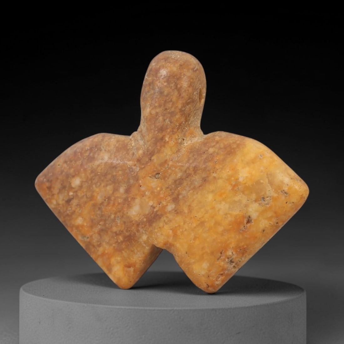 Ancient Egyptian Stone Amulet - Carved Ritual Idol, 59AE: Carved from beige stone, this amulet features a stylized anthropomorphic form with incised linear detailing, consistent with ancient Egyptian ritual idols of the Late Period. The piece has a suspensio