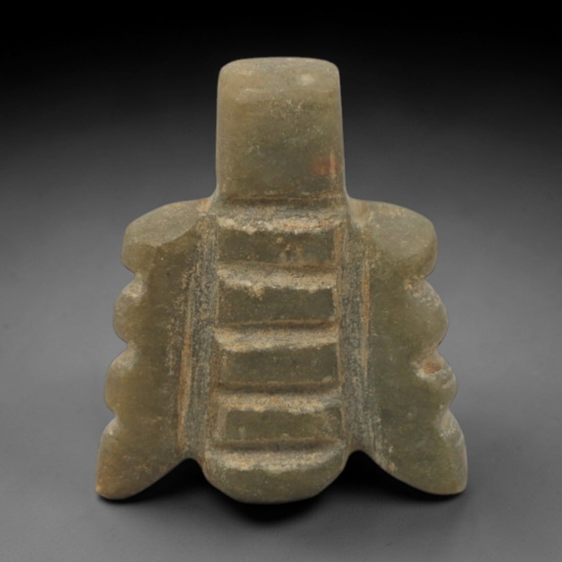 Ancient Stone Fly Amulet - Near Eastern Animal Pendant, 33XQ: This amulet is carved from a smooth, pale green stone, shaped into a stylized fly form with a raised rectangular suspension loop at the top, confirming its use as a wearable protective charm. The body