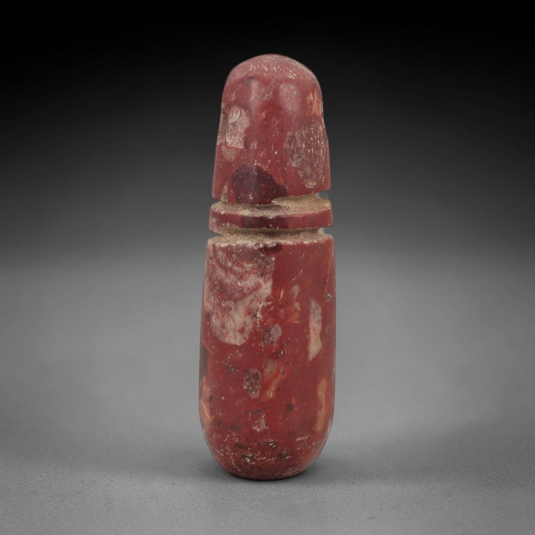 Ancient Egyptian Stone Amulet - Carved Ritual Pendant, 81AG: Carved from reddish-brown stone, this amulet features an elongated cylindrical form with incised linear detailing, consistent with ancient Egyptian ritual pendants of the Late Period. The shape is des