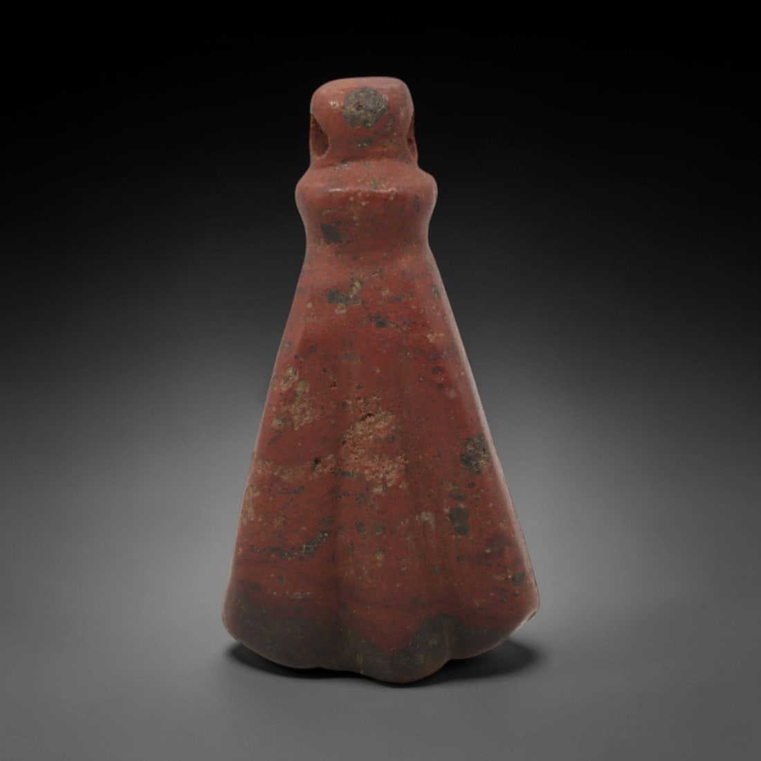 Ancient Stone Amulet - Near Eastern Anthropomorphic Pendant, 42XQ: This amulet is carved from a rich, red-banded stone, likely jasper, shaped into an anthropomorphic form with a perforated, rounded head at the top, confirming its use as a wearable protective charm. T
