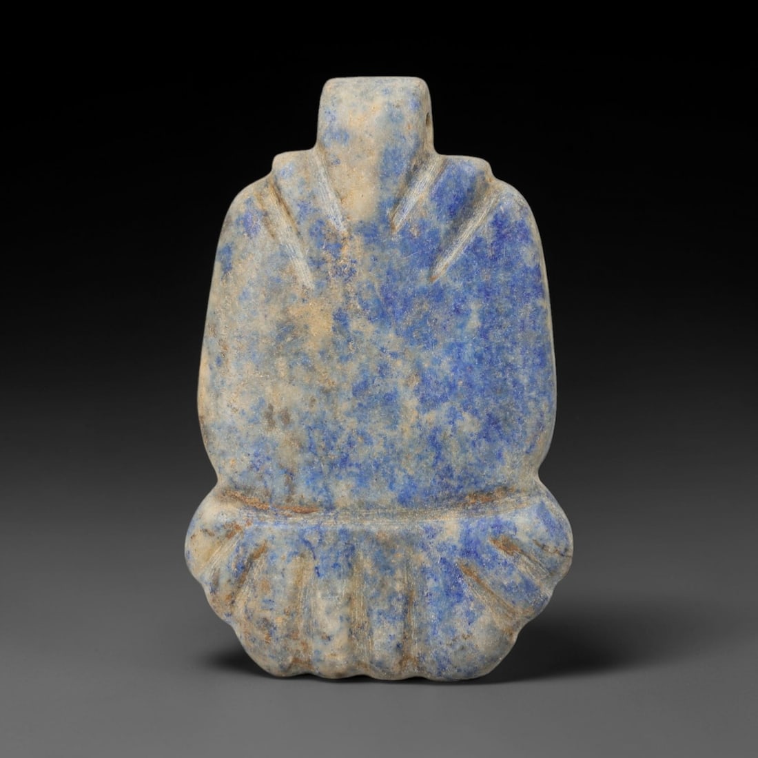 Ancient Lapis Lazuli Amulet - Achaemenid Carving, 39AH: Carved from lapis lazuli, this ancient Achaemenid amulet features a stylized, elongated form with natural inclusions and a deep blue hue characteristic of high-quality lapis. The piece is crafted with