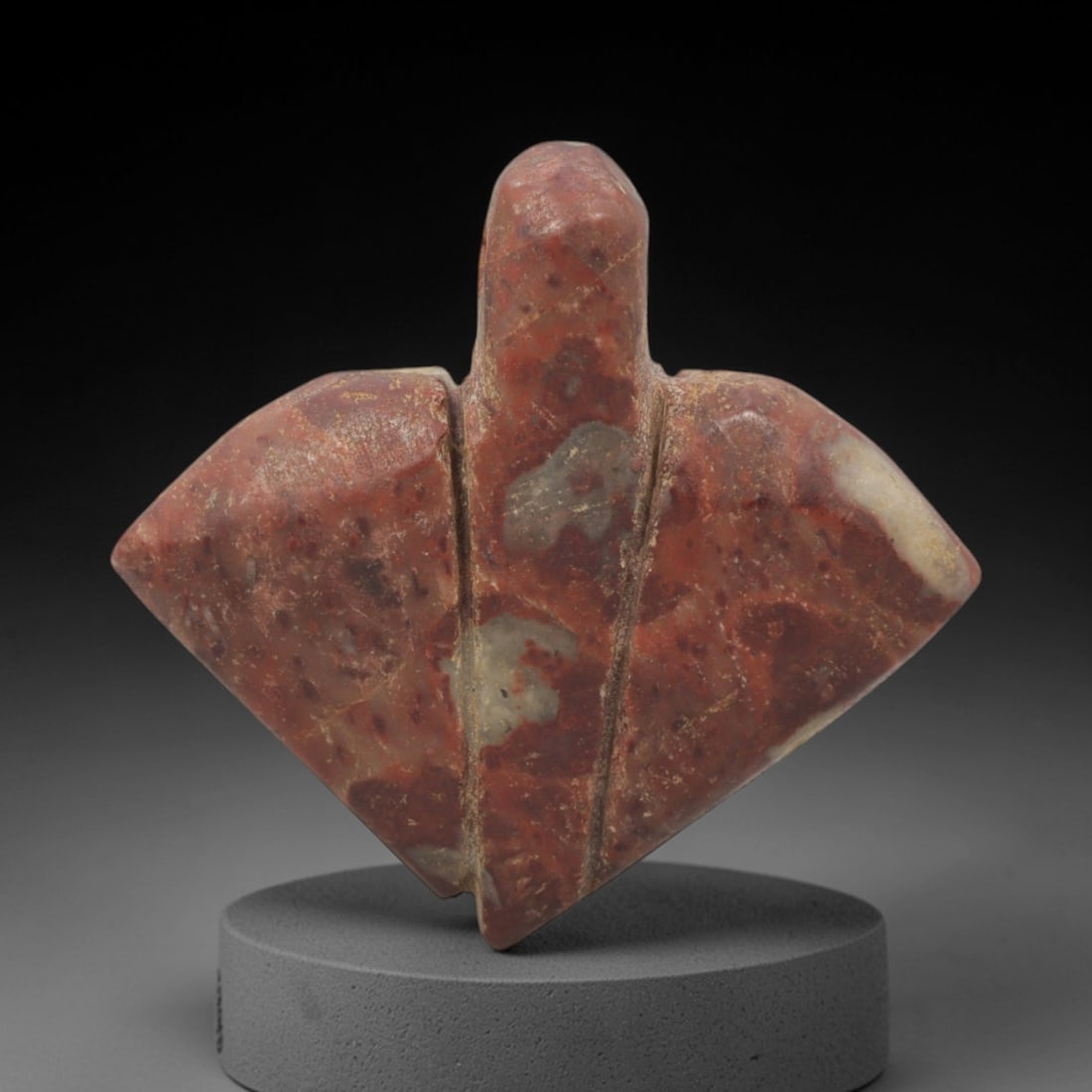 Ancient Stone Fly Amulet - Egyptian Ritual Figurine, 96XQ: Carved from a mottled reddish-brown stone with pale mineral inclusions, this amulet depicts a stylized fly form with a compact, rounded head and broad, diamond-shaped wings extending horizontally. Two