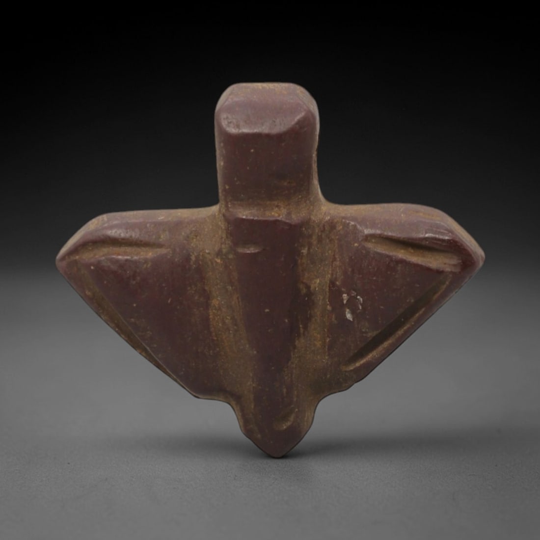 Ancient Stone Fly - Egyptian Amulet Pendant, 46XR: Carved from deep reddish-brown stone, this amulet depicts a stylized fly with outstretched wings, a compact body, and a drilled suspension hole at the top for threading as a wearable talisman. The for