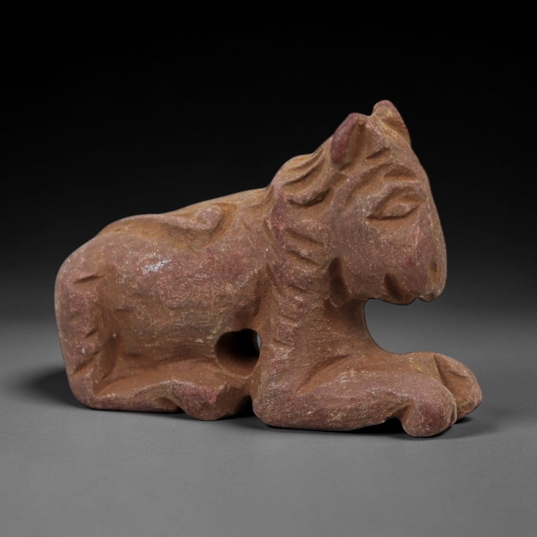 Ancient Limestone Feline Amulet - Miniature Relic, 18AH: Carved from limestone, this ancient feline amulet features a stylized, naturalistic rendering of a recumbent feline with detailed facial features and subtle body detailing. The stone exhibits a muted