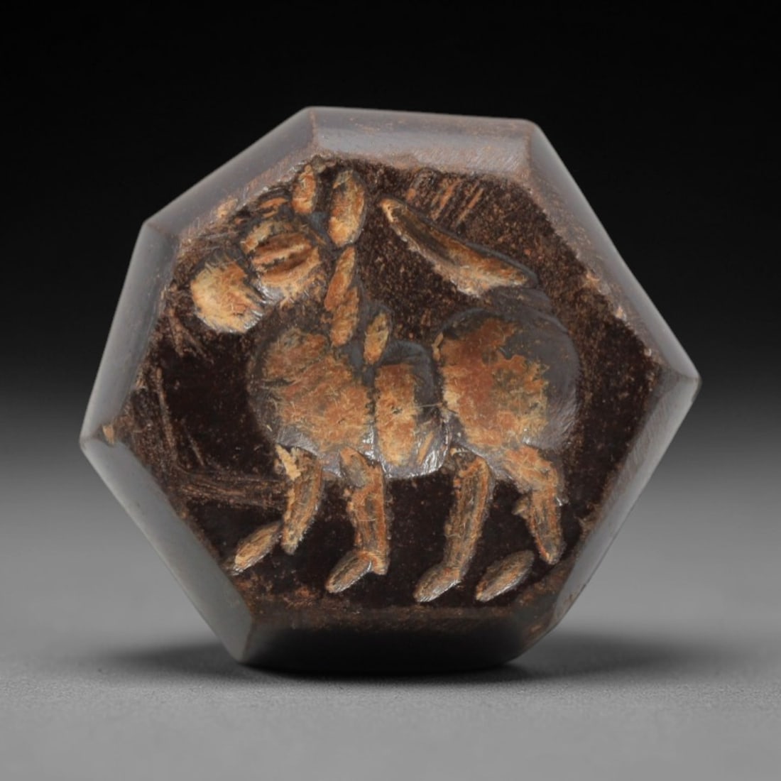 Ancient Hematite Hemispherical Stamp Seal - Near Eastern Carved Amulet, 56ZQ: Carved from hematite, this ancient Near Eastern hemispherical stamp seal features a finely detailed relief depicting a stylized animal form, typical of early Near Eastern glyptic art. The carving exhi
