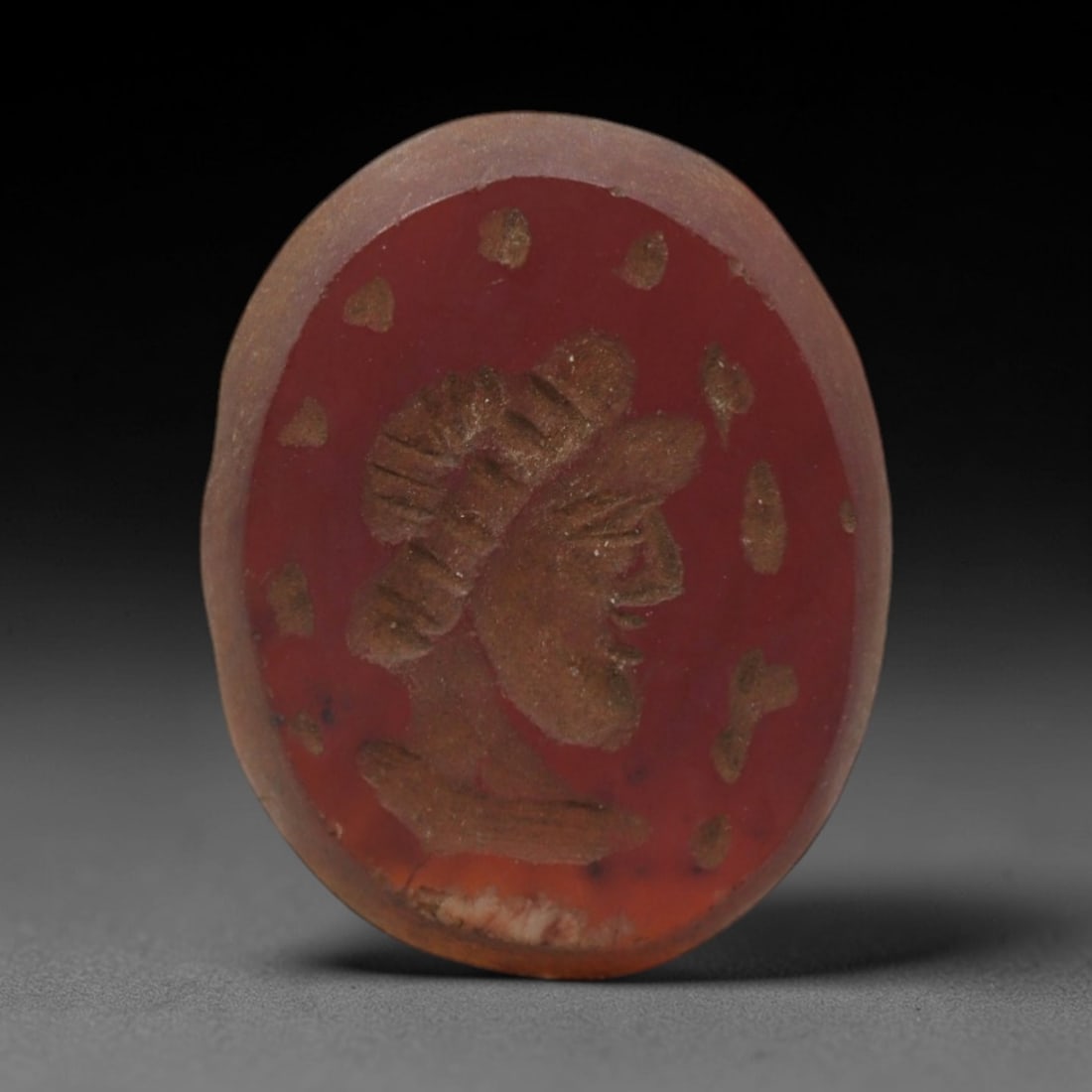Ancient Carnelian Intaglio - Near Eastern Carved Amulet, 51ZQ: Carved from carnelian, this ancient Near Eastern intaglio features a finely detailed relief portrait of a human head with distinctive facial features and hair detailing, typical of early Near Eastern