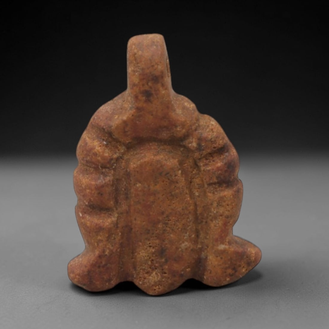 Ancient Stone Votive Pendant - Near Eastern Amulet, 23XR: Carved from dark grey stone, this miniature votive pendant features a cylindrical top section with a lateral suspension hole, a raised collar, and a bulbous lower body incised with vertical linear det