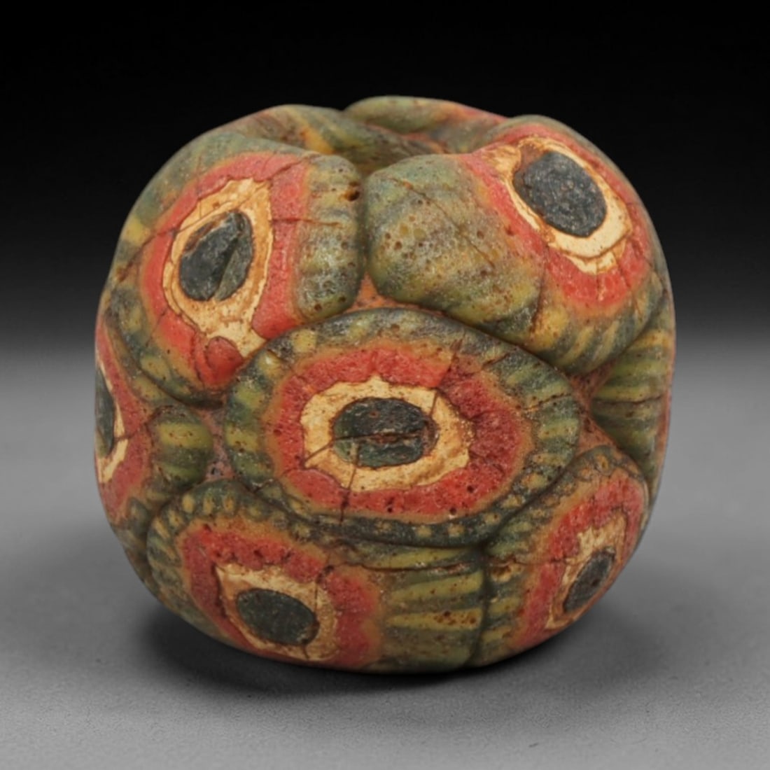 Ancient Islamic Glass Bead - Mosaic Eye Bead, 58ZN: Crafted from ancient glass, this Islamic period bead features a mosaic pattern with layered red, yellow, and white glass trails applied to a translucent base, characteristic of early Islamic decorativ