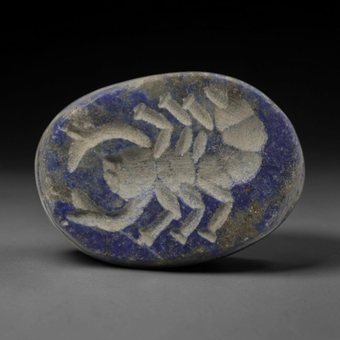 Ancient Lapis Lazuli Scorpion Stamp Seal - Egyptian Amulet, 5ZQ: Carved from deep blue lapis lazuli, this hemispherical stamp seal features a finely detailed scorpion motif on its convex face. The stone exhibits natural pyrite inclusions and a subtle, aged patina c