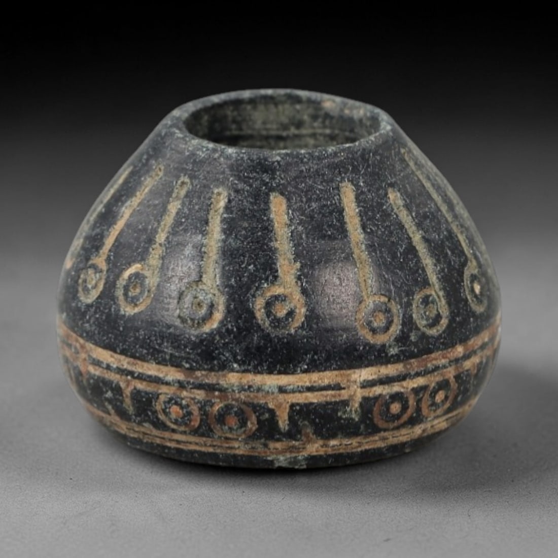 Ancient Bone Spindle Whorl - Near Eastern Radiating Dot Motif, 93AH: This ancient Near Eastern spindle whorl is crafted from bone, featuring a convex form with a central perforation. The surface is incised with radiating dot motifs arranged in concentric bands, a decor