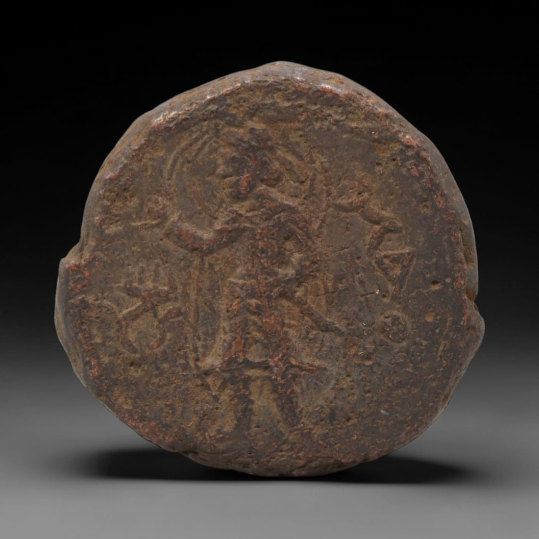 KUSHAN EMPIRE: Standing Deity - Bronze Coin, 26mm, 15.7g, 8AK: This bronze Kushan coin features a standing deity facing left, a key iconographic type that reflects the syncretic religious and cultural landscape of the empire. The figure's posture and attributes b