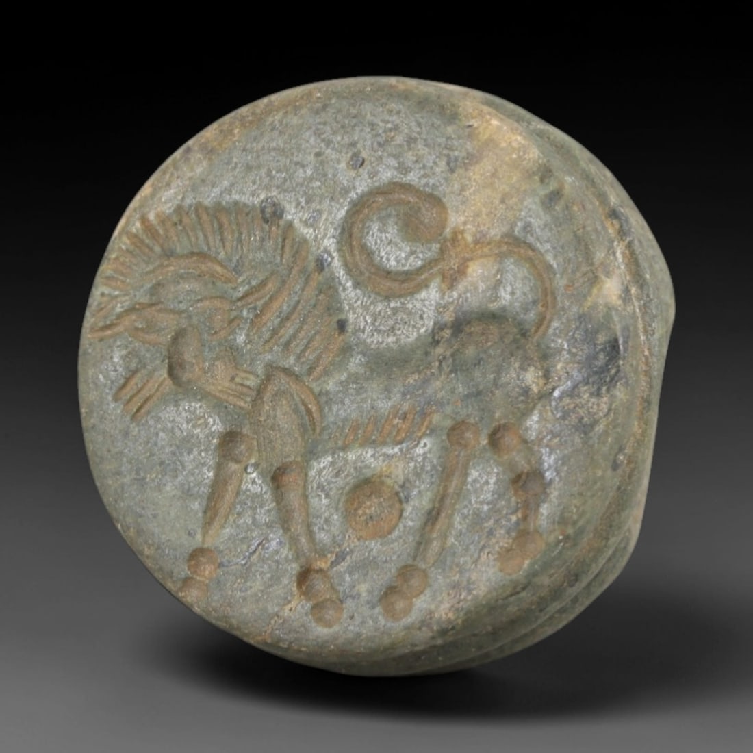 Ancient Steatite Stamp Seal - Sasanian Feline, 52AK: Carved from steatite, this hemispherical Sasanian stamp seal features a central stylized feline motif with incised details defining its mane, curled tail, and segmented limbs, consistent with Sasanian