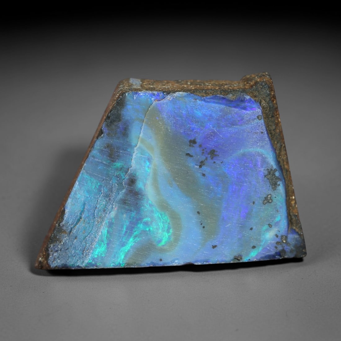 13.67 Carats Iridescent Blue-Green Winton Opal Rough - Natural Australian Specimen 19x13mm, 87XM: This exceptional rough opal from Winton, Australia, captivates with a vivid play of color, where intense flashes of celestial blue and vibrant green swirl through a milky, translucent base. The natura
