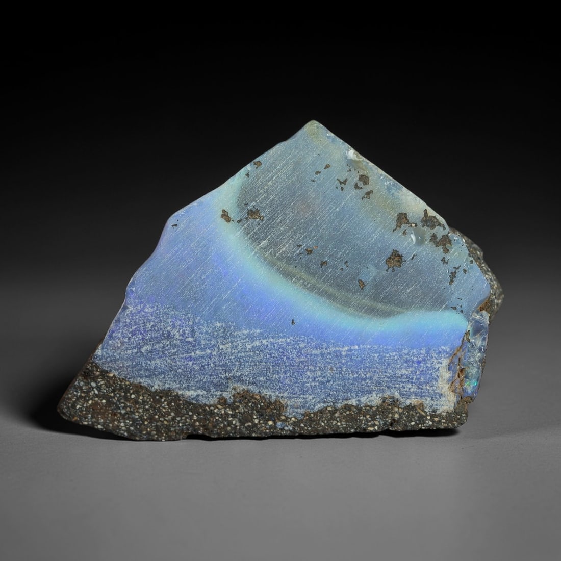 23.95 Carats Winton Boulder Opal Rough Slab - Natural Australian Stone, 36XP: This striking Winton boulder opal rough slab showcases a luminous band of ethereal sky-blue and pale aqua play-of-color, nestled within its natural ironstone host rock. Measuring precisely at 27.6 x 1