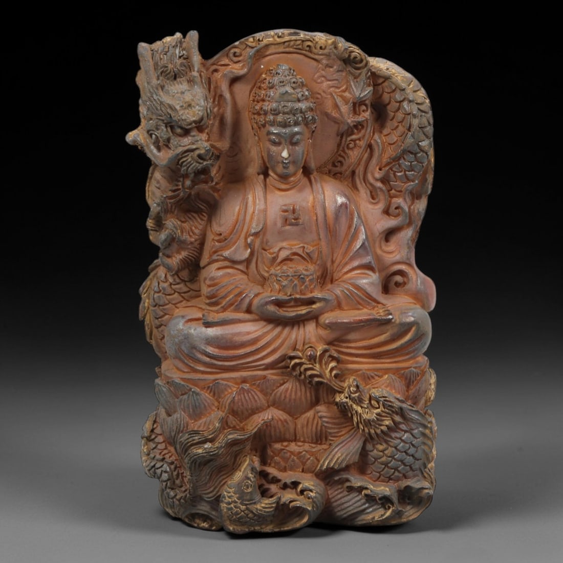 A Chinese Horn or Bone Buddhist Pendant Amulet, 20th Century, 92FV: Carved from horn or bone with a warm, reddish-brown patina and subtle tonal variations, the pendant is rectangular with an irregular, organic outline. The front face is deeply carved in high relief, d